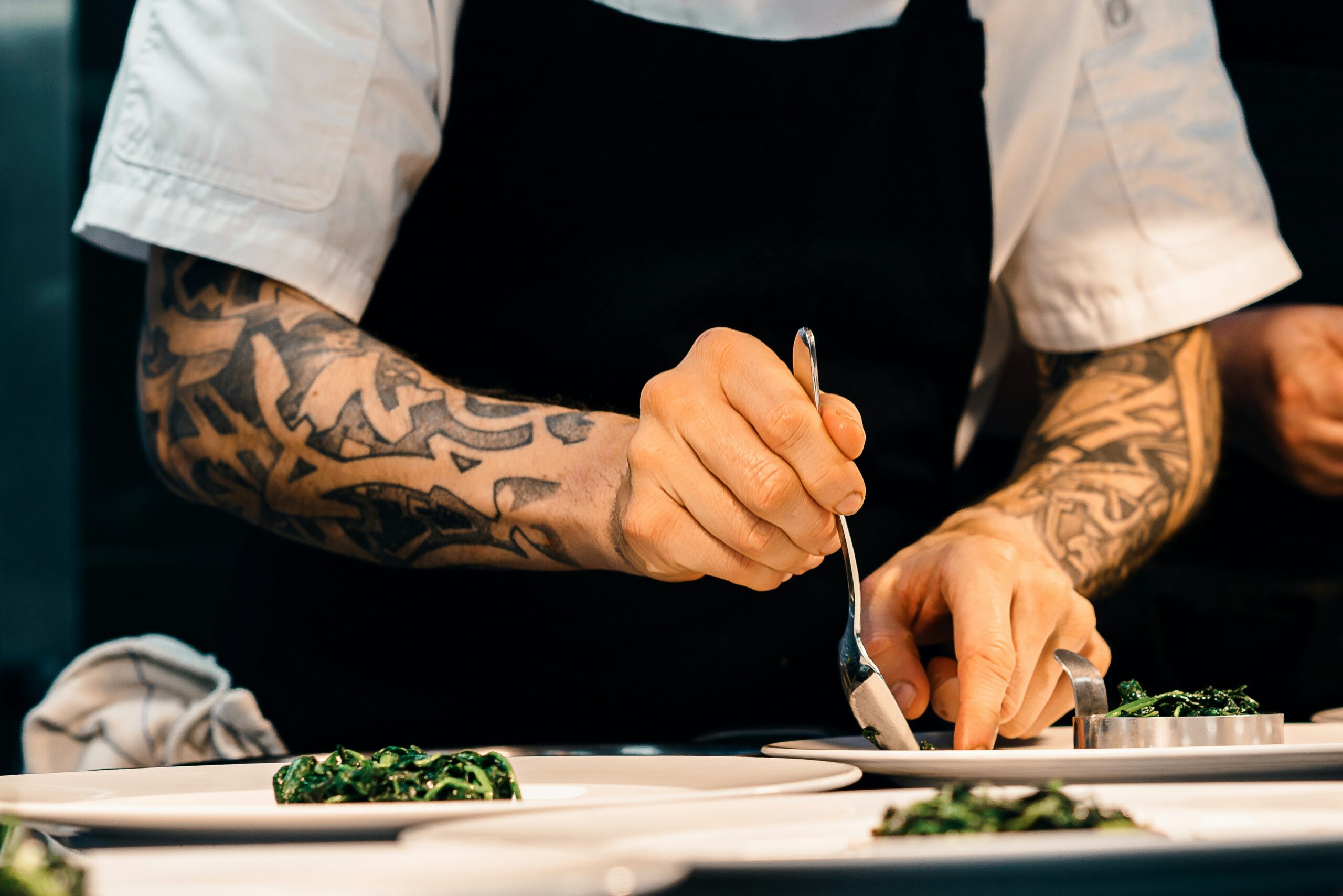 A man finishing his dishes to be served.